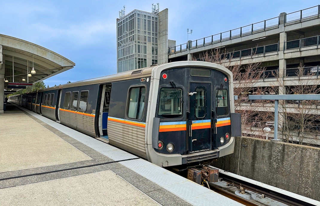 Atlanta Georgia train passing through scenic landscape with city skyline in the background.