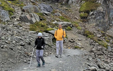 Tourists hiking on rocky path during Ushuaia Martial Glacier Tour.