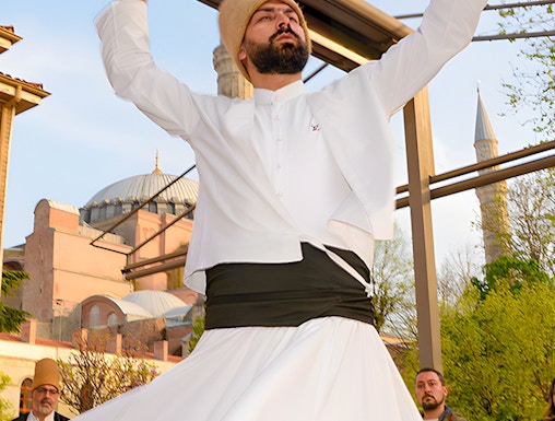 Whirling Dervish performing in front of a mosque in Istanbul.