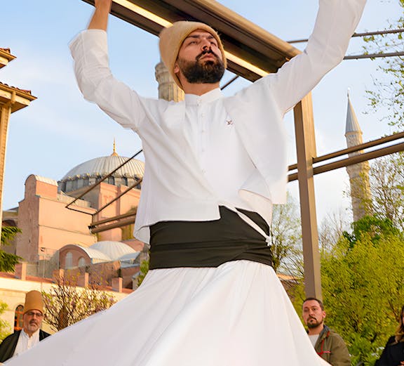 Whirling Dervish performing in front of a mosque in Istanbul.