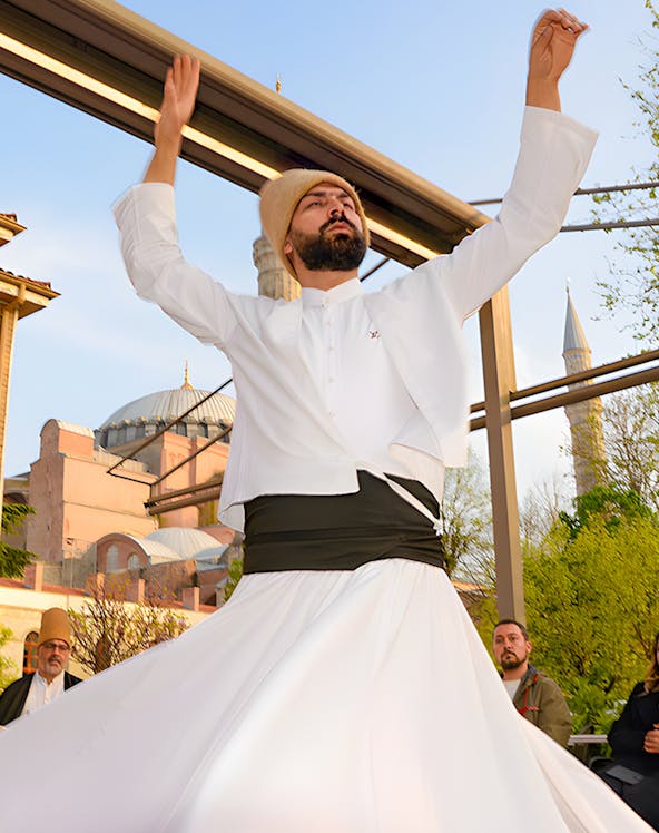 Whirling Dervish performing in front of a mosque in Istanbul.