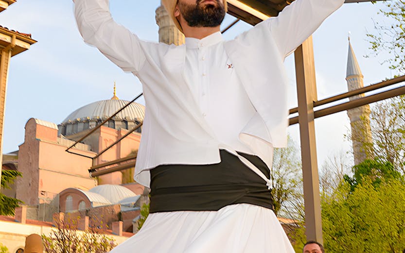 Whirling Dervish performing in front of a mosque in Istanbul.