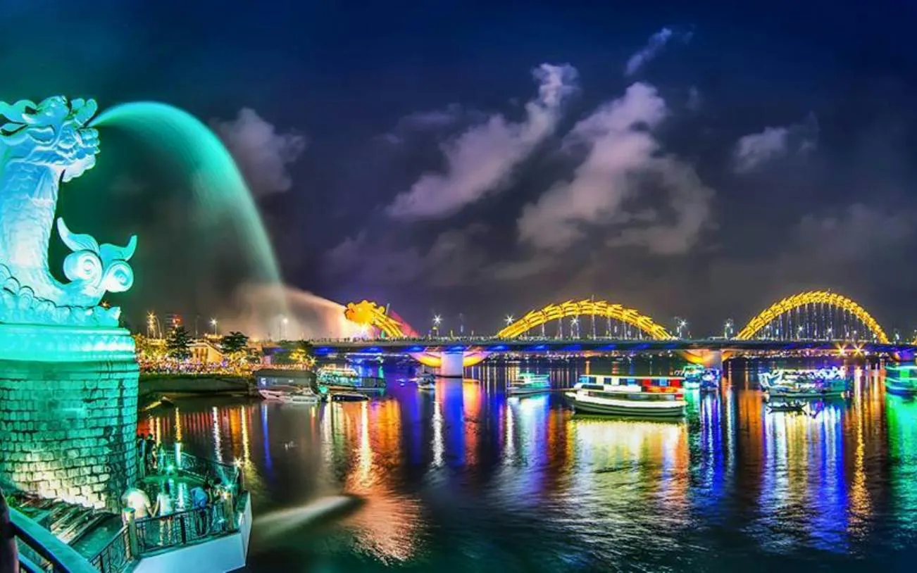 Dragon Bridge and Han River at night with colorful lights, Da Nang, Vietnam.