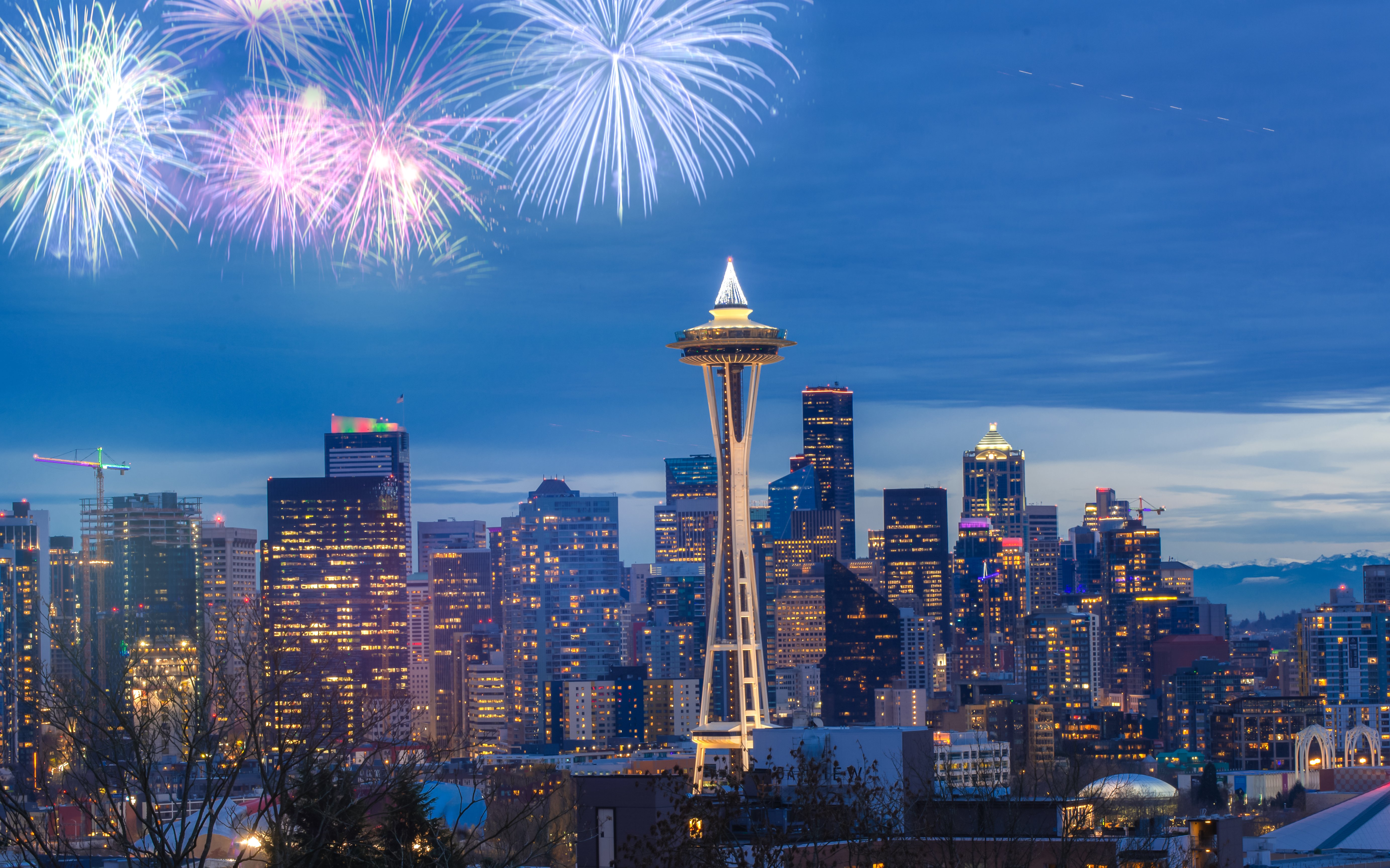 Seattle Space Needle with fireworks in the night sky.