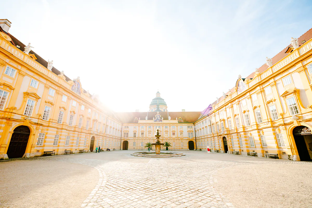 Melk Abbey courtyard with fountain, part of Hallstatt Highlights Day Trip from Vienna.