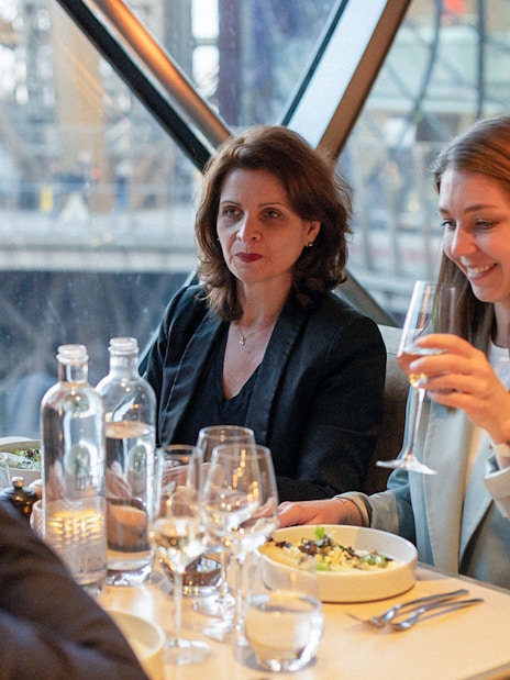 Lunch at Madame Brasserie, Eiffel Tower, with diners enjoying a meal and drinks.