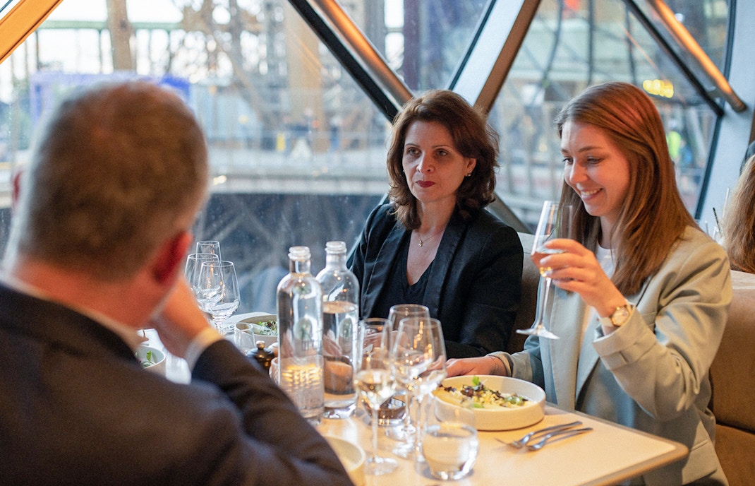 Lunch at Madame Brasserie, Eiffel Tower, with diners enjoying a meal and drinks.