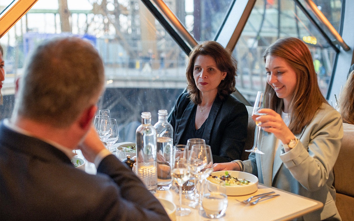 Lunch at Madame Brasserie, Eiffel Tower, with diners enjoying a meal and drinks.