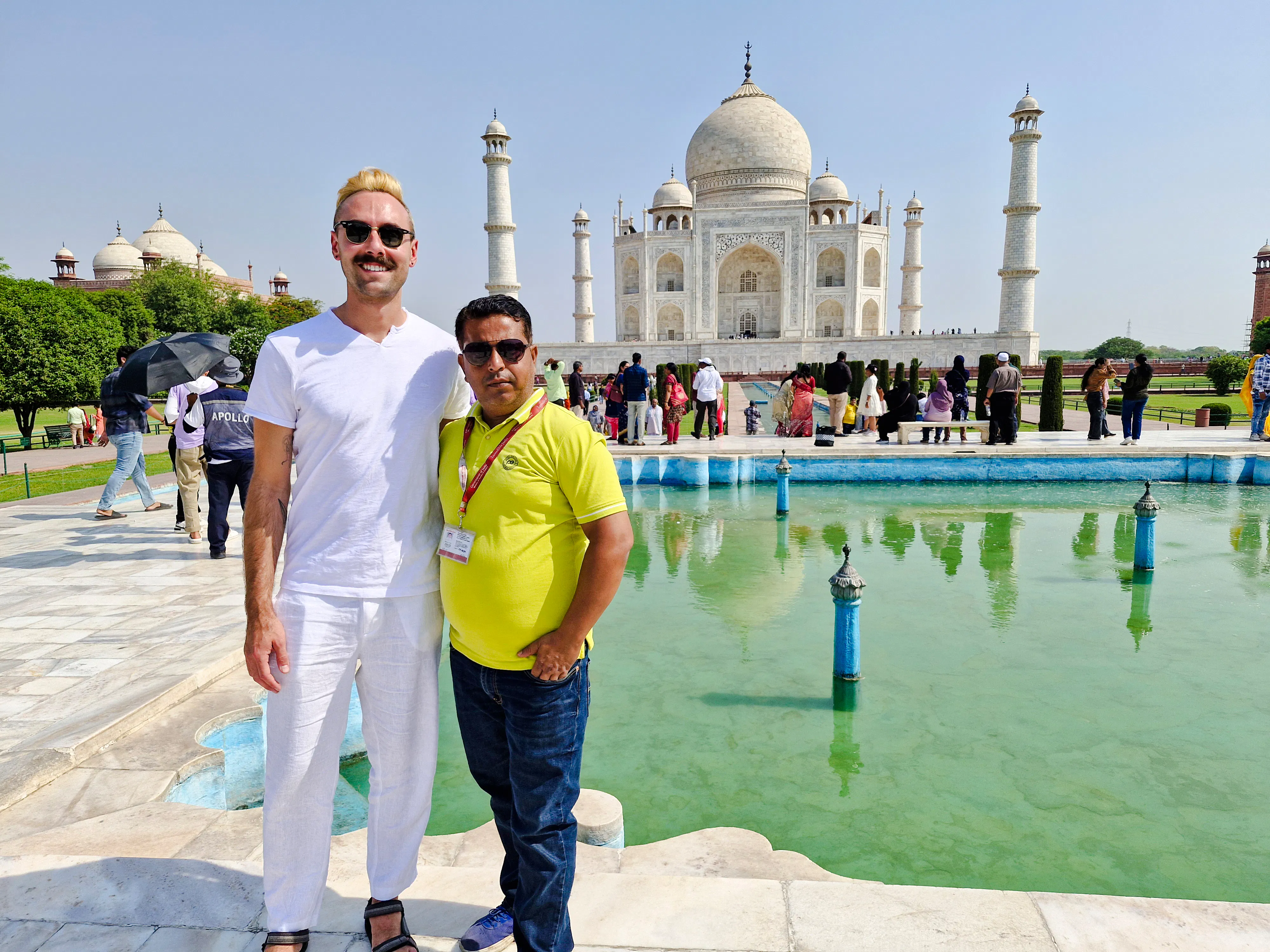 Tourists at the Taj Mahal with reflecting pool, part of the Agra day tour from Delhi.