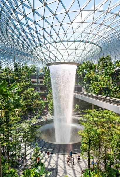 Jewel Changi indoor waterfall surrounded by lush greenery in Singapore.