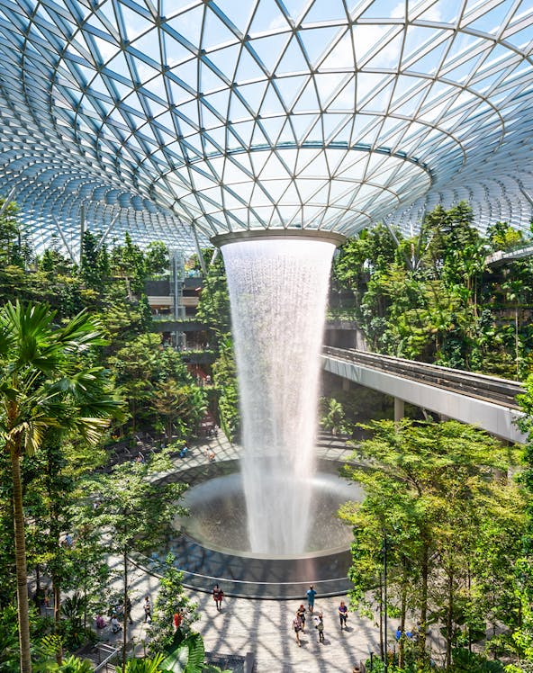 Jewel Changi indoor waterfall surrounded by lush greenery in Singapore.