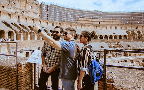 Tourists taking a selfie inside the Colosseum during an express guided tour.