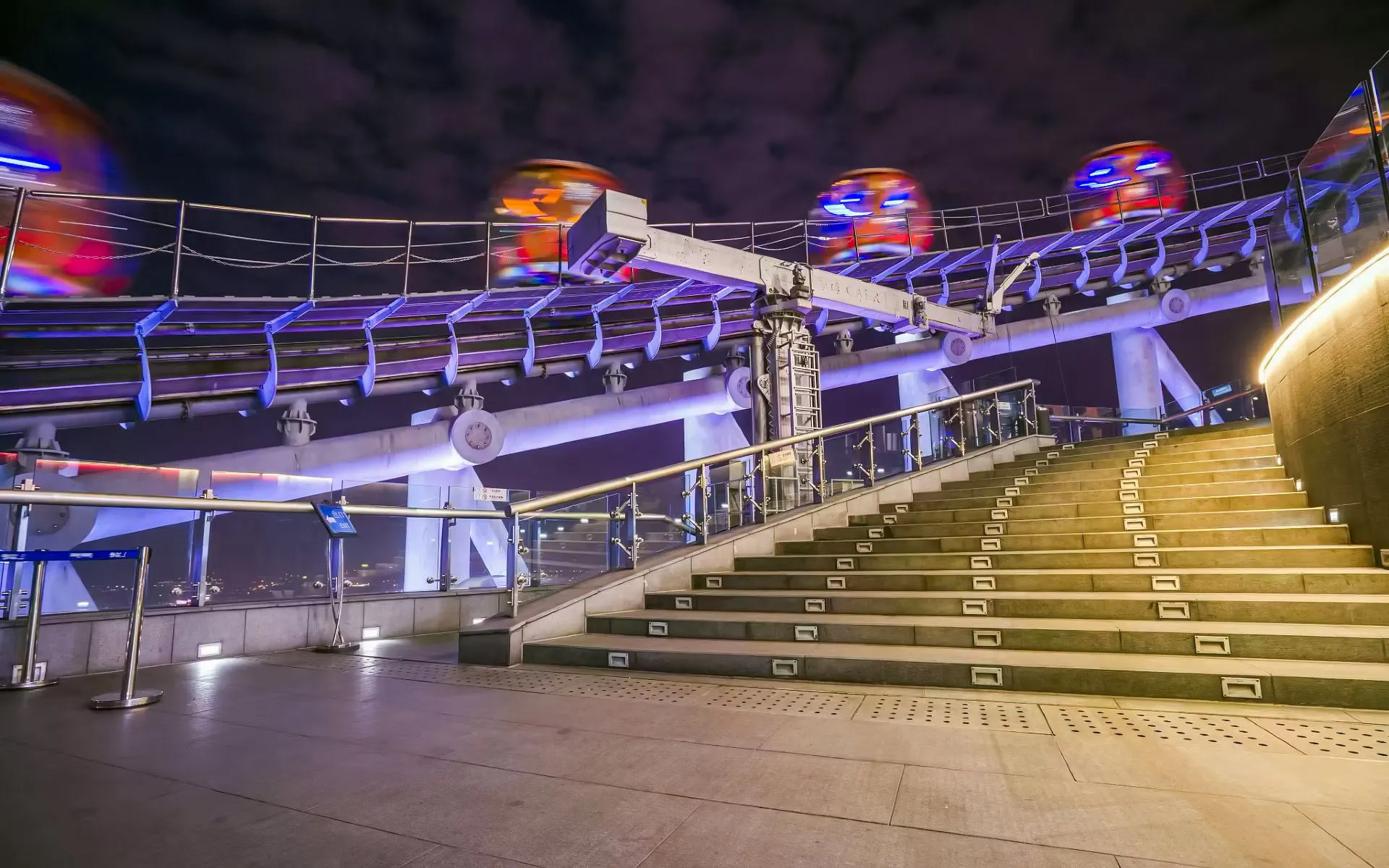 Elevated ramp leading to Bubble Tram at Canton Tower, Guangzhou, with trams in motion above.