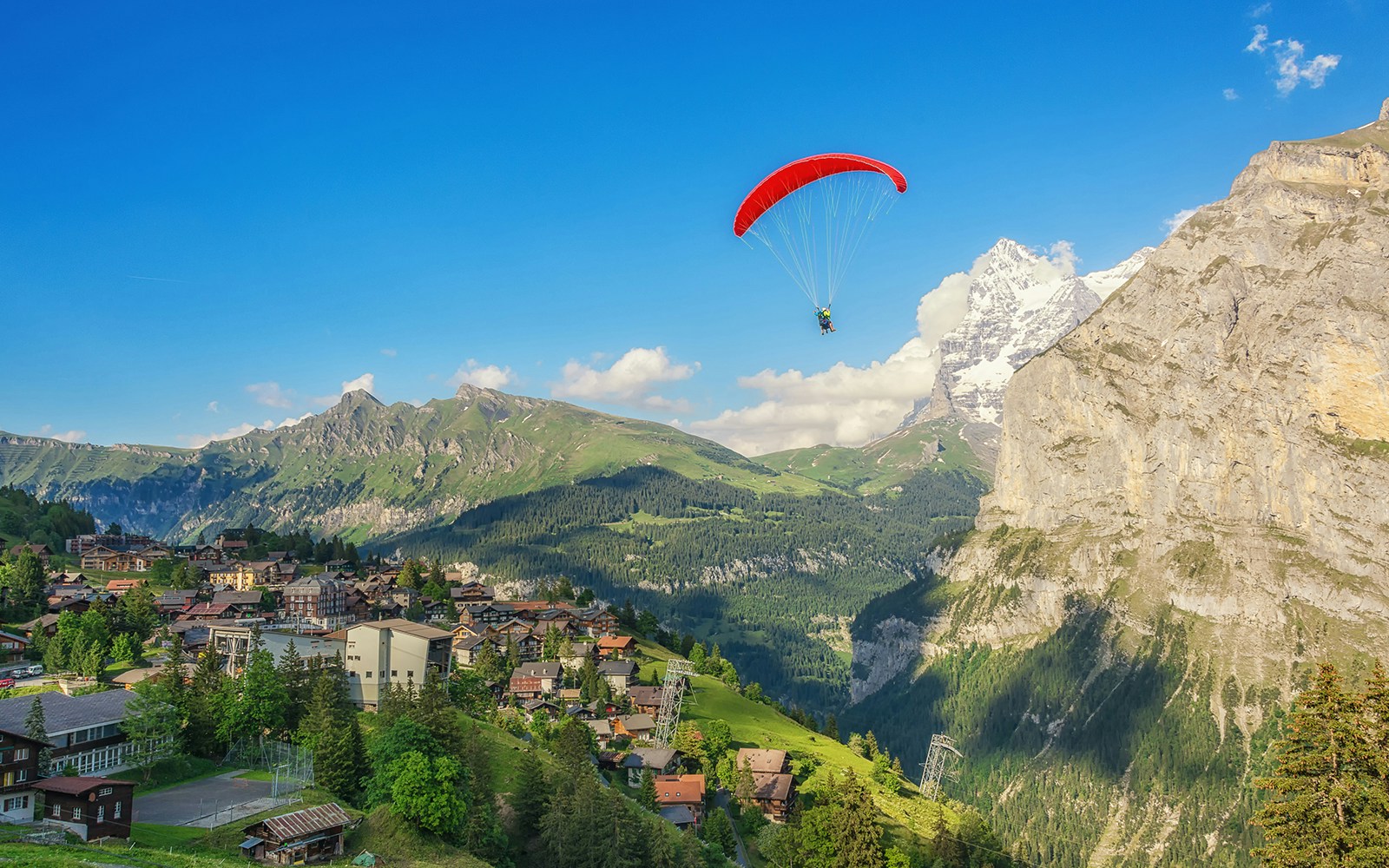 Paragliding over Murren, Switzerland with views of picturesque alpine surroundings.