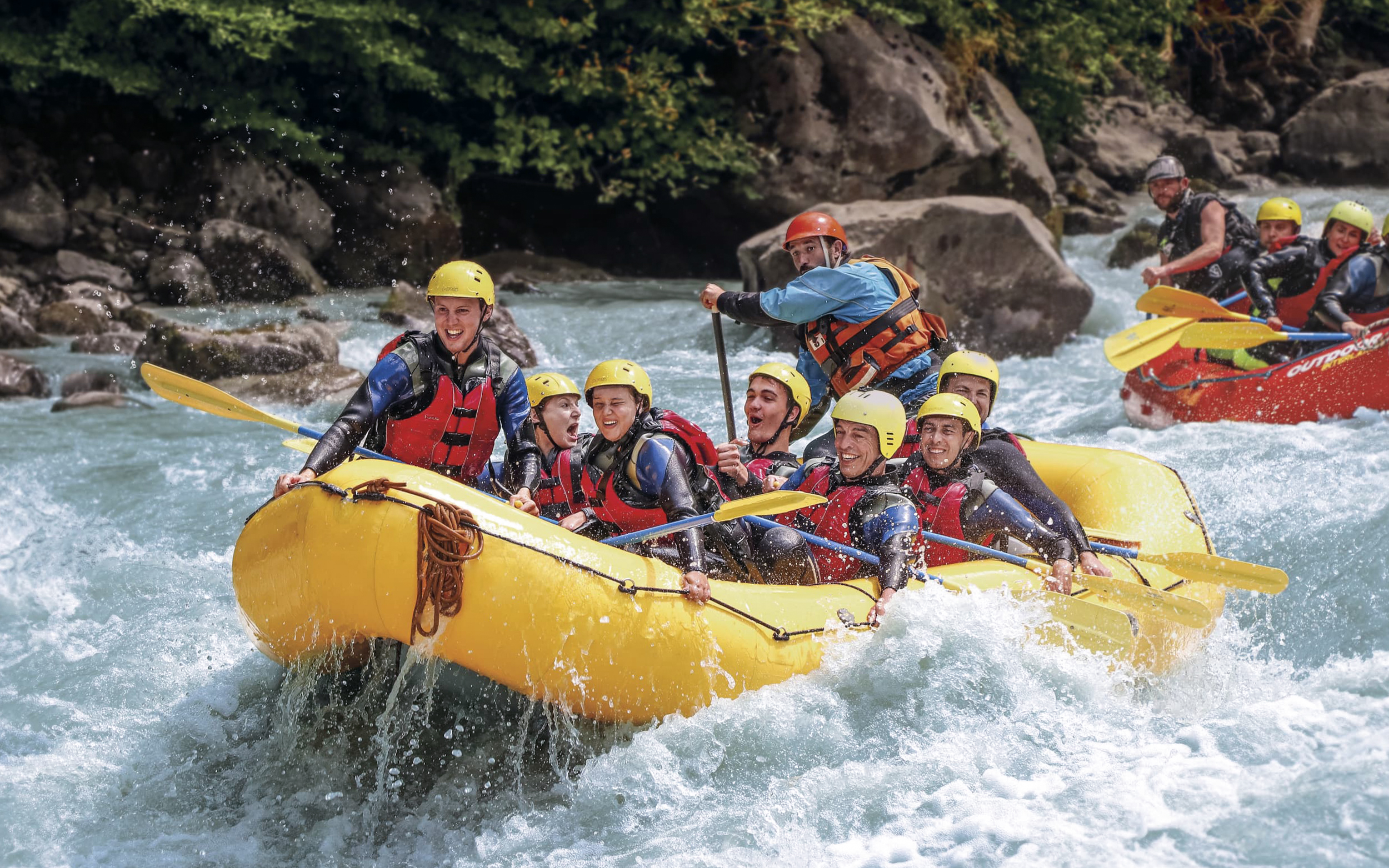 River rafting group navigating rapids in Interlaken.