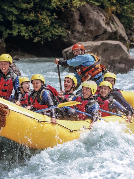 River rafting group navigating rapids in Interlaken.