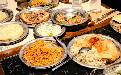 Traditional Turkish dinner spread with kebabs, pilaf, and mezze dishes in Istanbul.