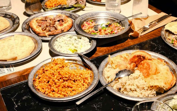 Traditional Turkish dinner spread with kebabs, pilaf, and mezze dishes in Istanbul.