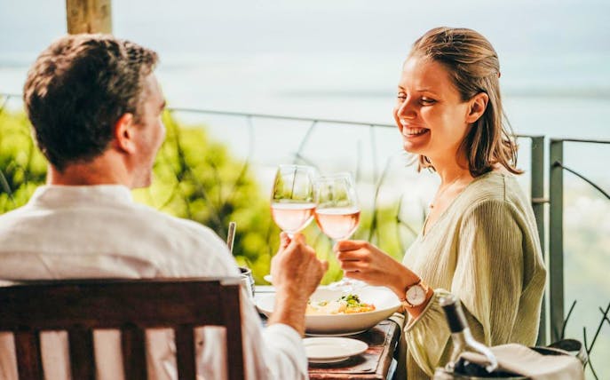 Couple enjoying lunch with wine at Coloured Earth, Chamarel, Mauritius.