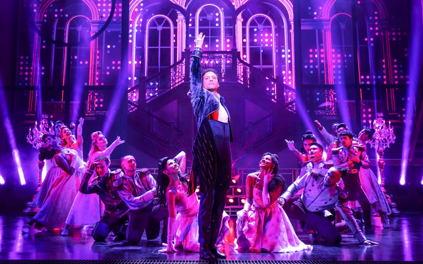 Performers in a theatrical scene from "Once Upon a One More Time" with vibrant lighting.