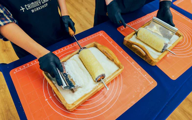 Participants preparing chimney cakes at a workshop in Budapest.