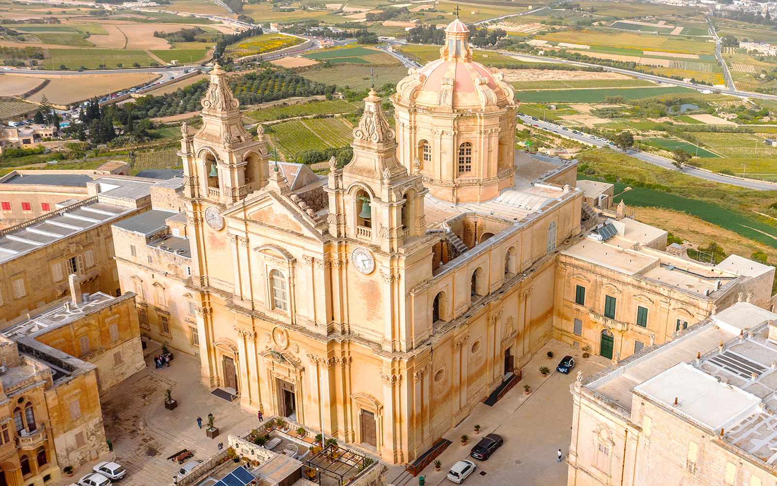 St. Paul’s Cathedral exterior with tourists in Valletta, Malta.