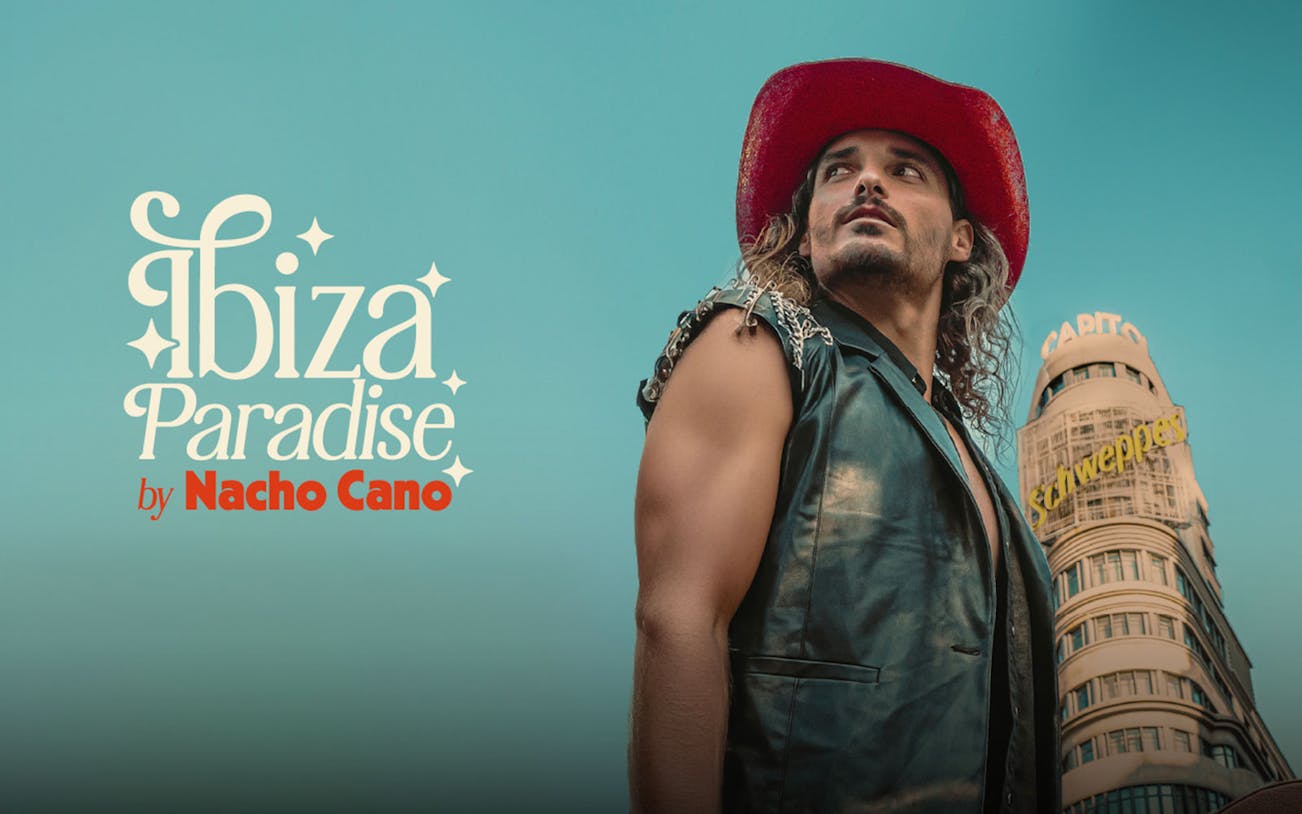 Performer in red hat in front of Madrid's Capitol Building for Ibiza Paradise by Nacho Cano show.