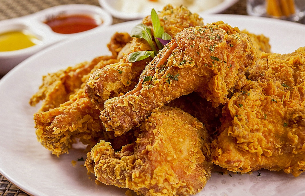 Korean fried chicken served on a plate with dipping sauce