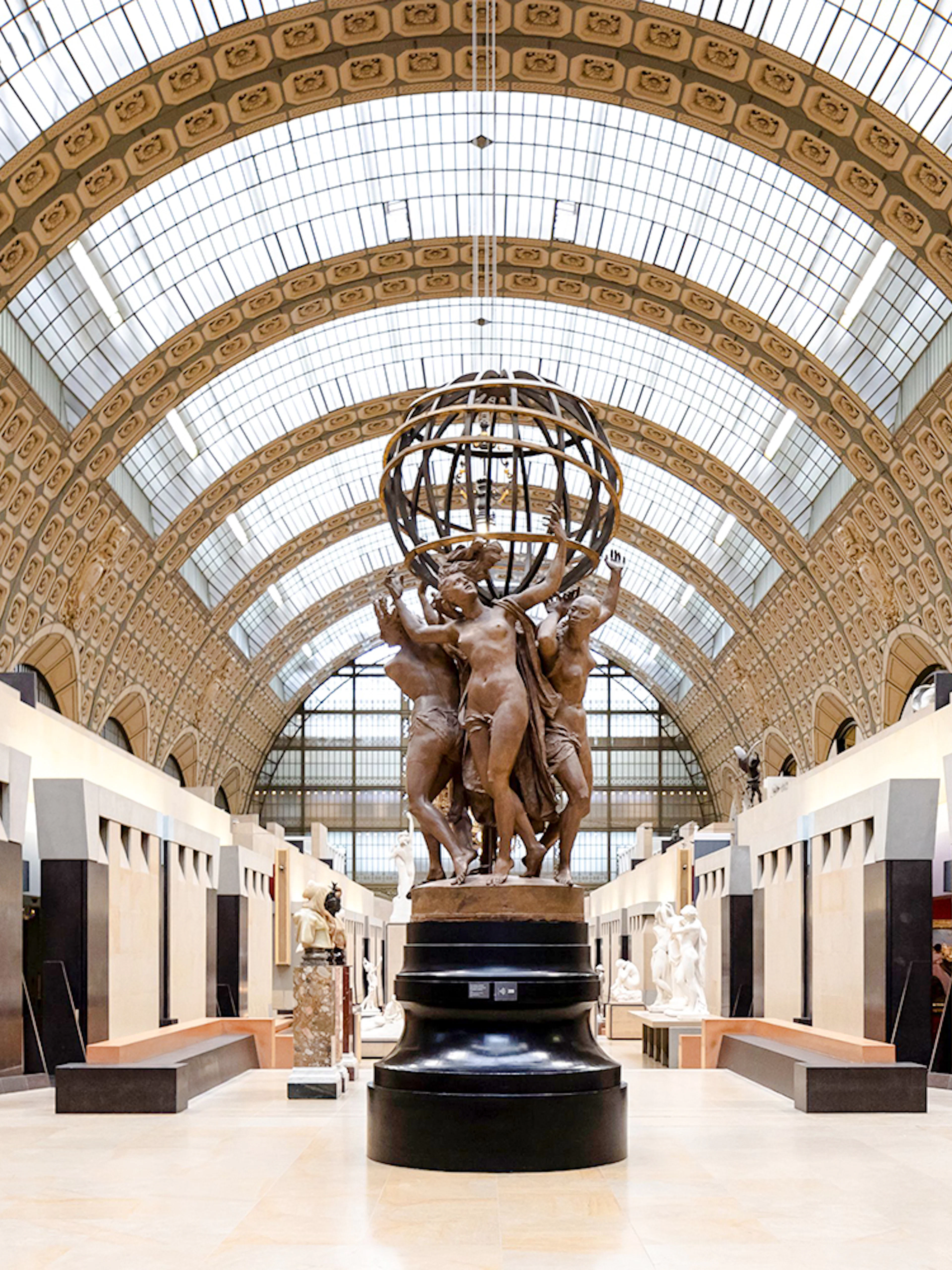Orsay Museum interior with sculptures and ornate ceiling, Paris, France.