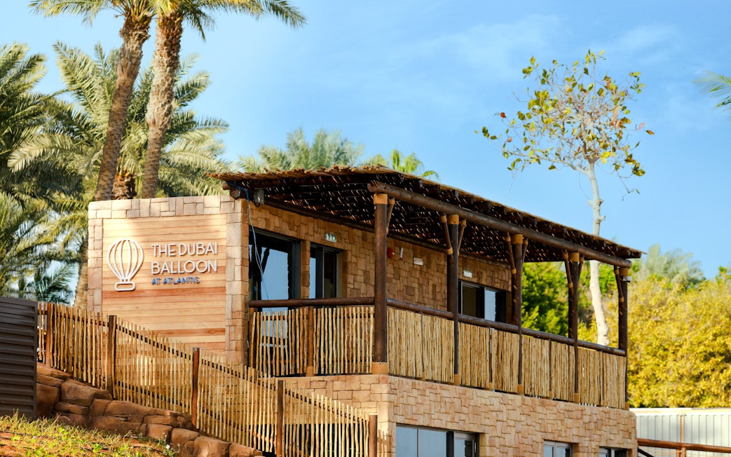 The Dubai Balloon building at Atlantis surrounded by palm trees.