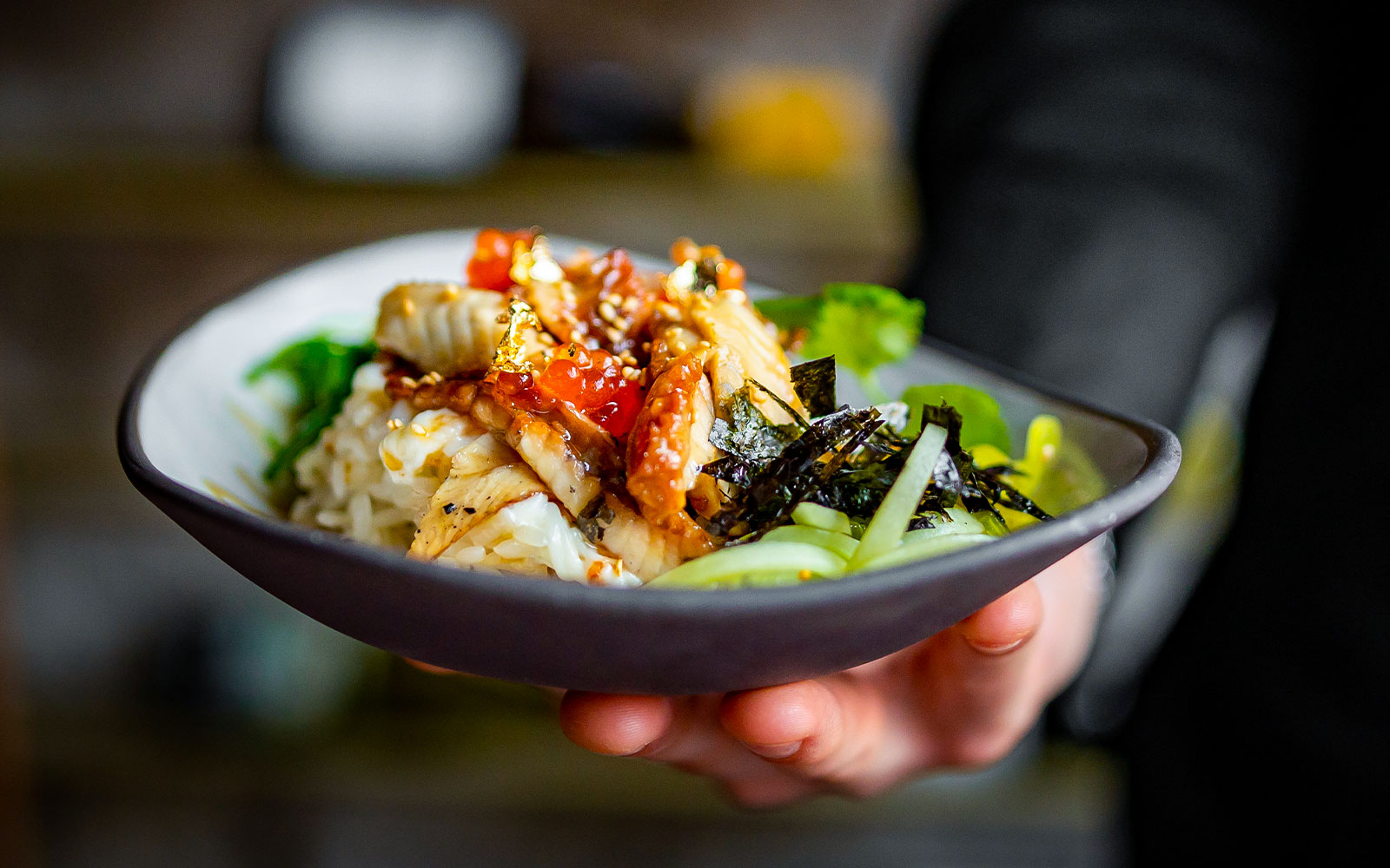 Chef holding a bowl of food