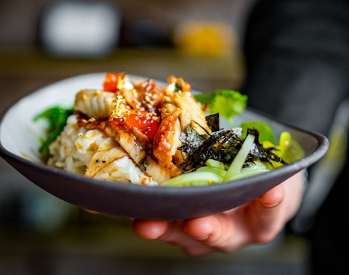 Chef holding a bowl of food