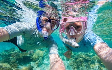 Snorkelers exploring coral reefs at Giftun Island, Hurghada.