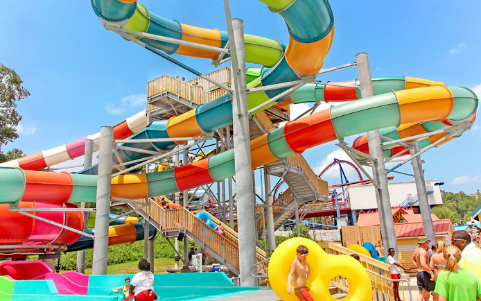Colorful water slides at Six Flags Over Georgia with visitors enjoying the attraction.