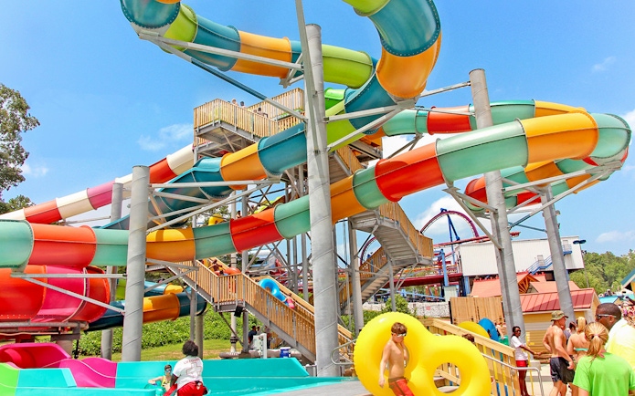 Colorful water slides at Six Flags Over Georgia with visitors enjoying the attraction.