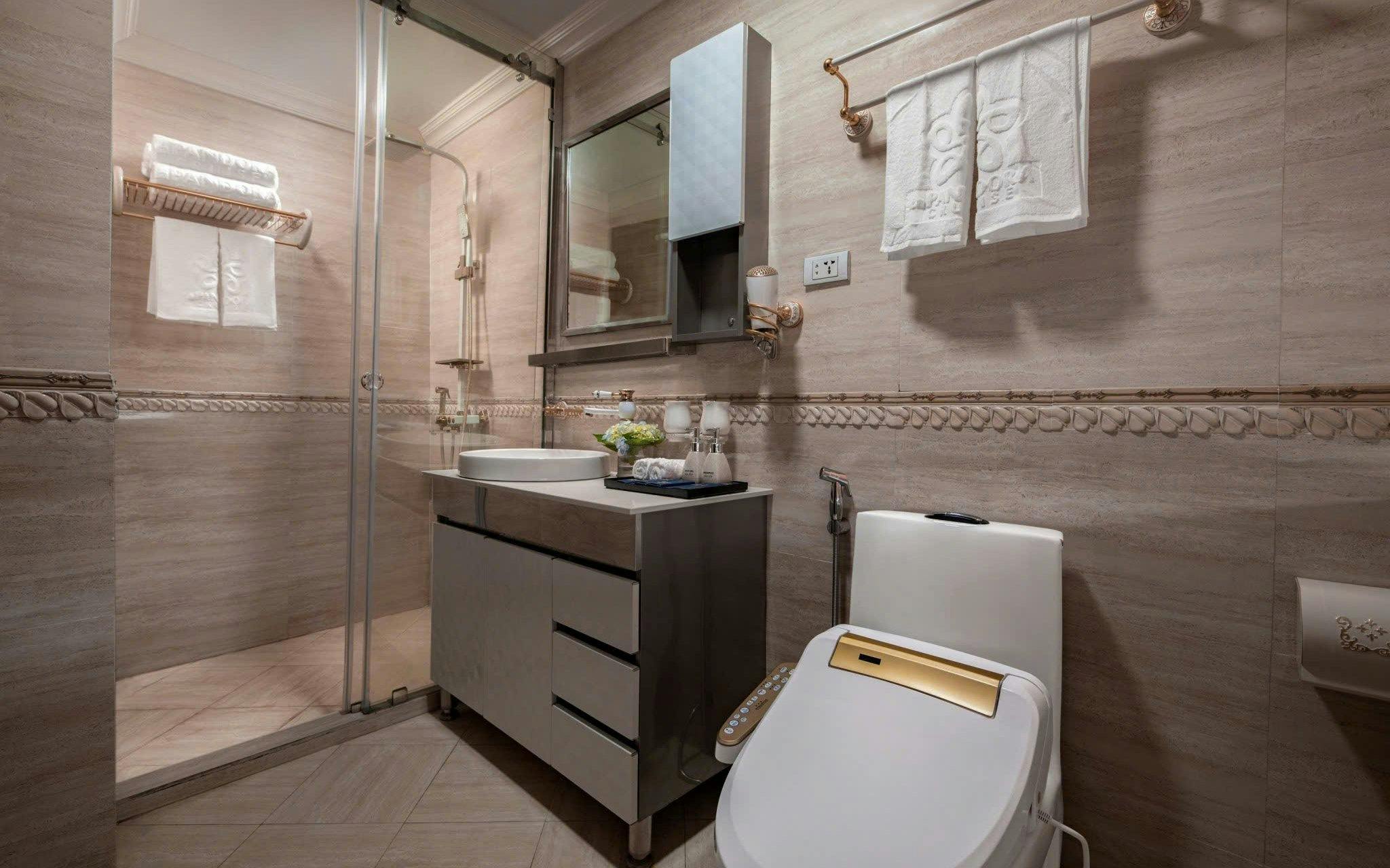 Luxurious bathroom on Lan Ha Bay cruise with modern amenities.
