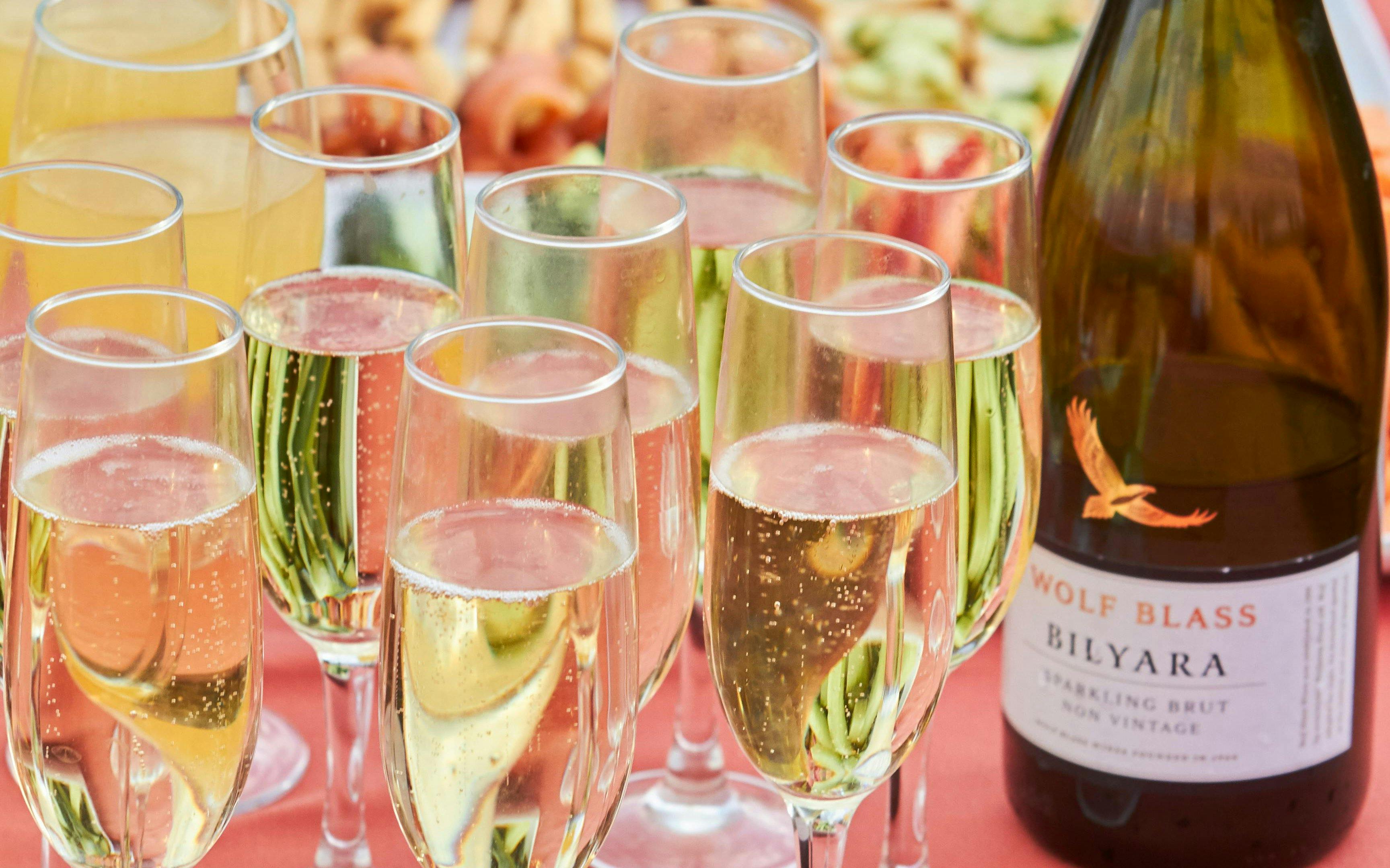 Sparkling wine glasses on Uluru sunset tour table.