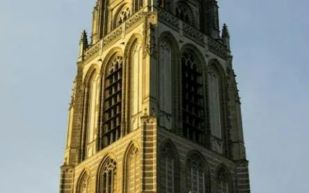 Rotterdam's historic church tower under evening sky, part of self-guided city exploration game.