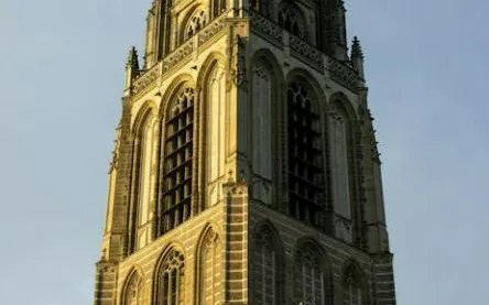 Rotterdam's historic church tower under evening sky, part of self-guided city exploration game.