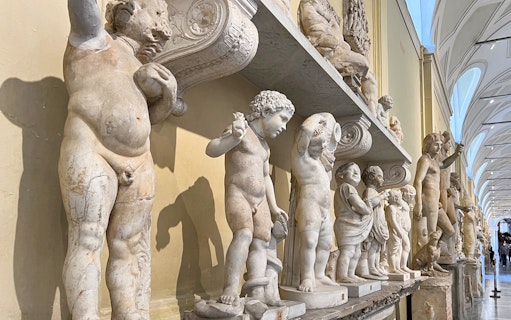 Marble statues in the Vatican Museums corridor, part of the skip-the-line tour.