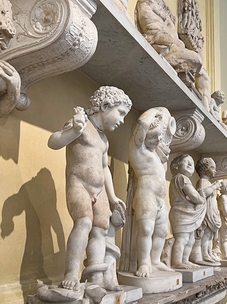 Marble statues in the Vatican Museums corridor, part of the skip-the-line tour.