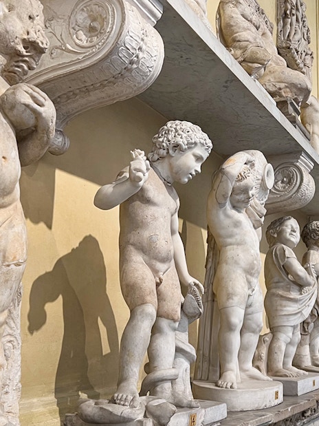 Marble statues in the Vatican Museums corridor, part of the skip-the-line tour.