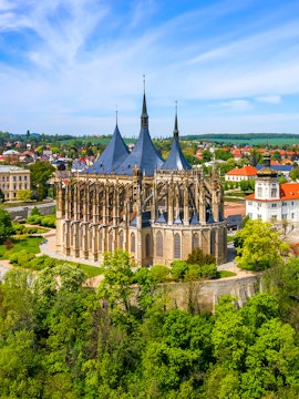 St. Barbara's Church in Kutna Hora with surrounding greenery and town view.