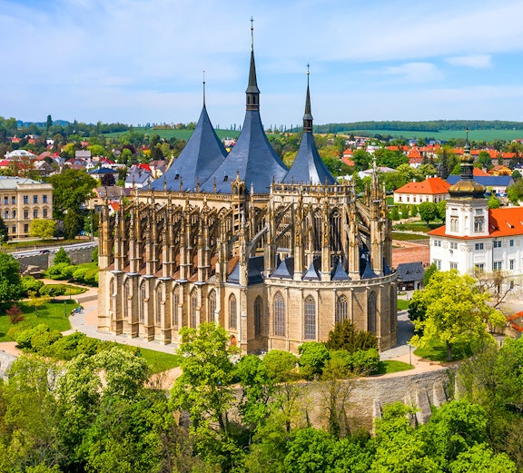 St. Barbara's Church in Kutna Hora with surrounding greenery and town view.