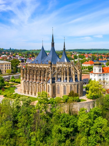 St. Barbara's Church in Kutna Hora with surrounding greenery and town view.