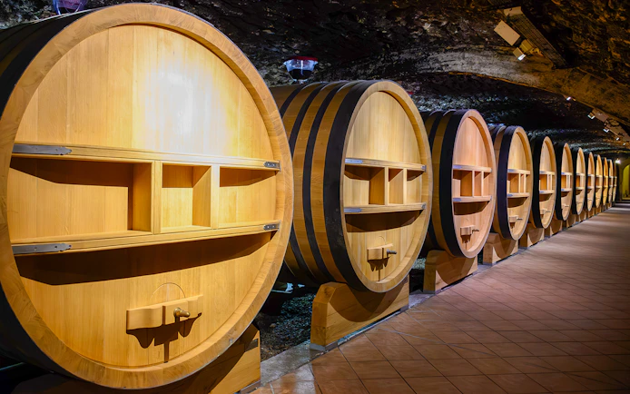 Barrels in underground wine cellars, Chateauneuf-du-Pape, Provence.