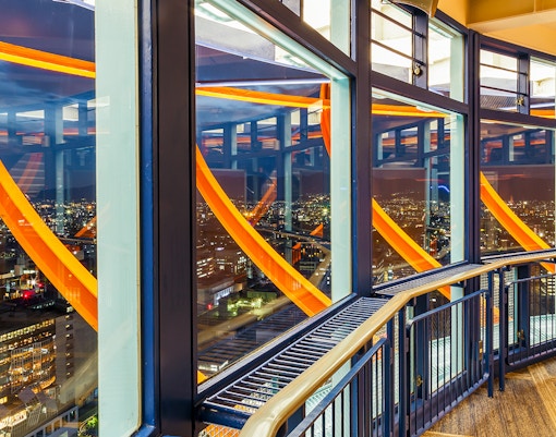 The lit up observation deck of Kyoto Tower after sunset
