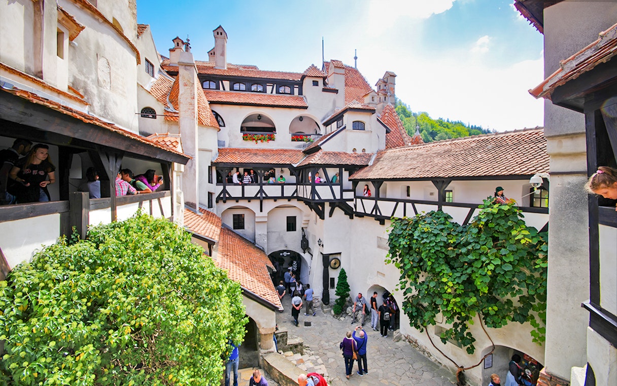 Bran Castle courtyard with stone walls and arched windows, Transylvania, Romania.