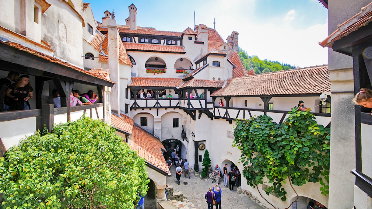Bran Castle courtyard with stone walls and arched windows, Transylvania, Romania.