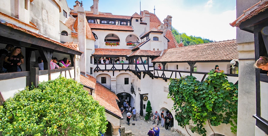 Bran Castle courtyard with stone walls and arched windows, Transylvania, Romania.